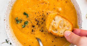 Butternut Squash Cheddar Soup in a bowl with bread