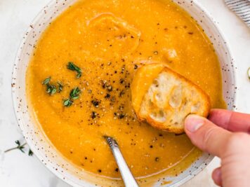Butternut Squash Cheddar Soup in a bowl with bread